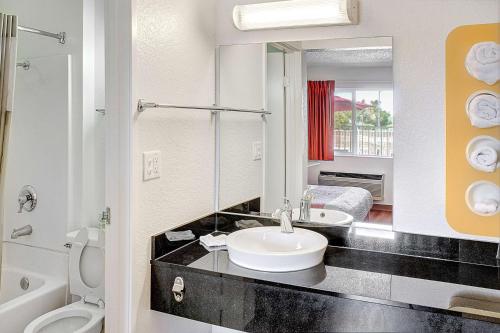 a bathroom with a sink and a toilet at Motel 6-Lancaster, CA in Lancaster