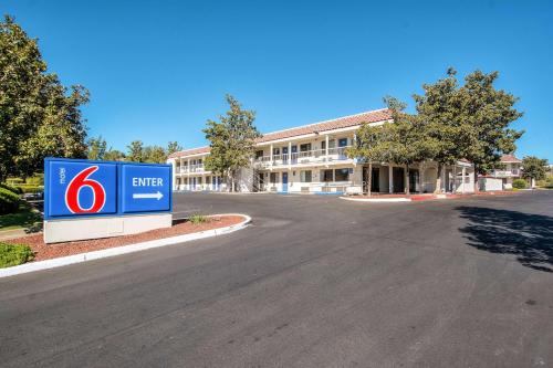 a building with a sign in the middle of a road at Motel 6-Redding, CA - South in Redding