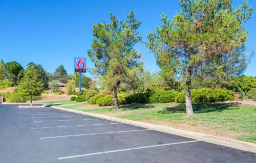 an empty parking lot with a no parking sign at Motel 6-Redding, CA - South in Redding
