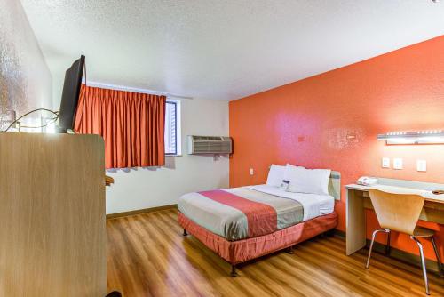 a hotel room with a bed and a desk at Motel 6-Portland, OR - Tigard West in Tigard