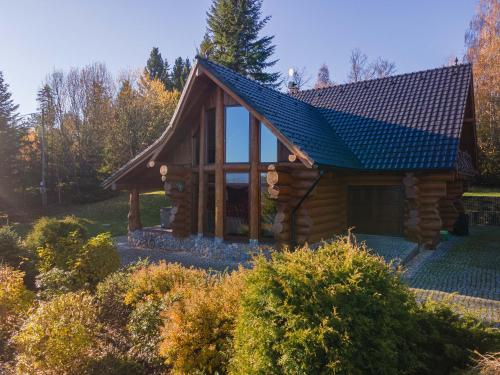 a log cabin with a blue roof at Srub Eden in Frýdek-Místek