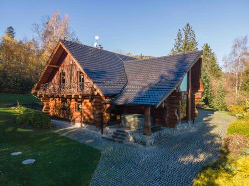 a log cabin with a slate roof and a porch at Srub Eden in Frýdek-Místek