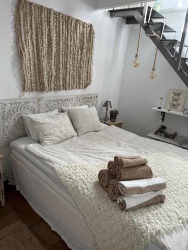 a bedroom with a bed with towels on it at Cozy Townhouse Altea in Altea