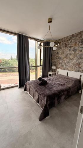 a bedroom with a bed and a large window at The Caesar Stay in Caesarea