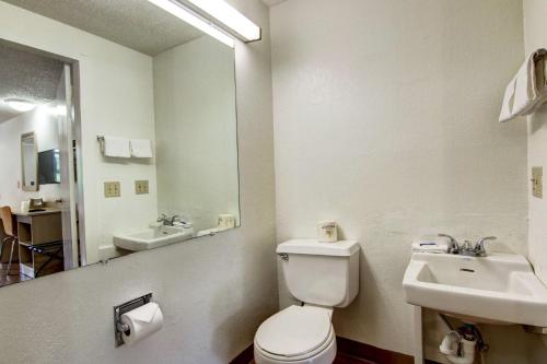 a bathroom with a toilet and a sink and a mirror at Motel 6-Union City, GA - Atlanta Airport in Union City