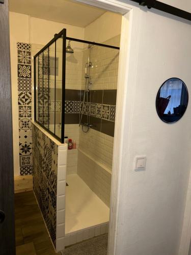 a bathroom with a walk in shower next to a staircase at Larcadian in Boulogne-sur-Mer