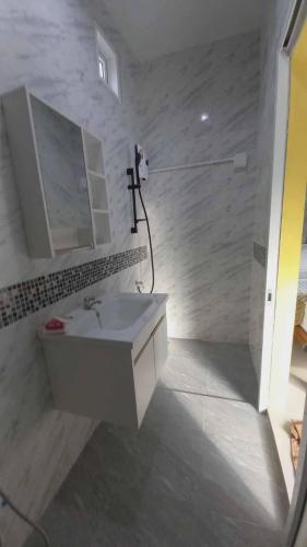a white bathroom with a sink and a shower at Pool Villa Rai View Khao in Ban Klang