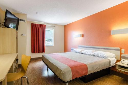 a hotel room with a bed and a television at Motel 6-Bristol, VA in Bristol