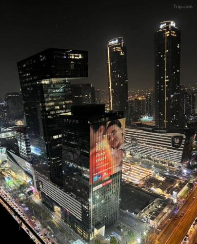 a view of a city at night with buildings at WSTAR Hostel in Bangkok