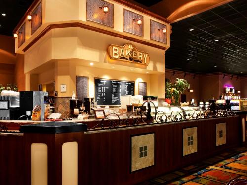 a bar in a restaurant with a counter with chairs at Chukchansi Gold Resort & Casino in Coarsegold