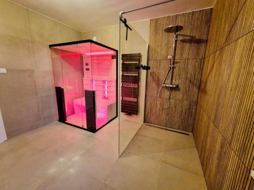 una doccia in vetro in un bagno con illuminazione rosa di Haus Waldbach - nahe Nassfeld - Pressegger See a Köstendorf