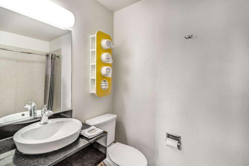 a bathroom with a white toilet and a sink at Motel 6-Visalia, CA in Visalia