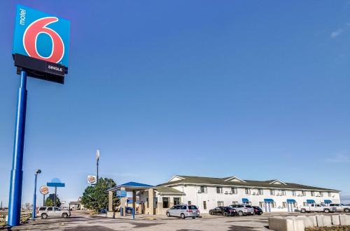a gas station with a sign in a parking lot at Motel 6-Colby, KS in Colby