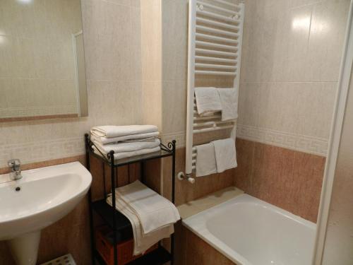 a bathroom with a sink and a bath tub next to a sink at Cal Feliuet in Passanant i Belltall