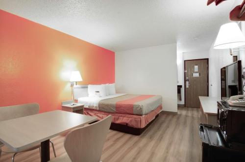 a hotel room with a bed and a table at Motel 6-Colby, KS in Colby