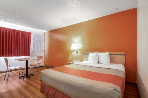 a hotel room with a bed and a table at Motel 6-Colby, KS in Colby