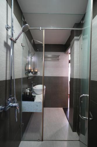 a bathroom with a shower with a sink and a toilet at Nana Villa Hue in Hue