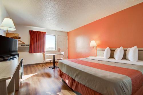 a hotel room with a large bed and a desk at Motel 6-Colby, KS in Colby