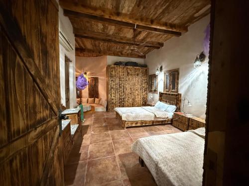 a large room with two beds and a couch at Paloma Lodge Guest House in Siwa