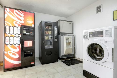 a laundry room with a soda machine and a washer at Motel 6-Colby, KS in Colby