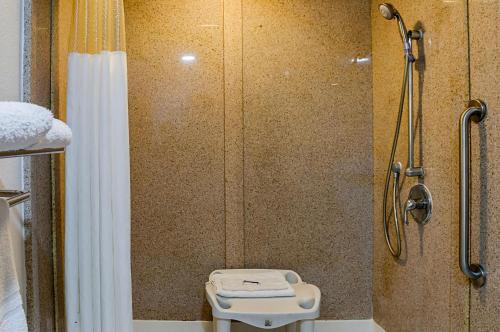 a bathroom with a shower with a toilet and a shower curtain at Motel 6-New Orleans, LA - Near Downtown in New Orleans