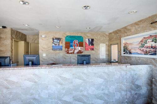 a bar with two chairs in a room at Motel 6-Santa Fe, NM - Downtown in Santa Fe
