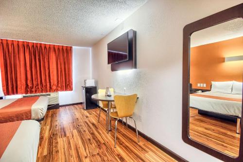 a hotel room with two beds and a mirror at Motel 6-Columbus, OH - West in Columbus