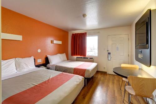 a hotel room with two beds and a table at Motel 6-Amherst, OH - Cleveland West - Lorain in Amherst