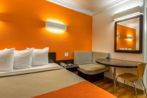 a hotel room with a bed and a small table at Motel 6-Menifee, CA in Menifee