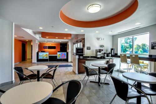 a restaurant with tables and chairs and a kitchen at Motel 6-Allentown, PA in Allentown