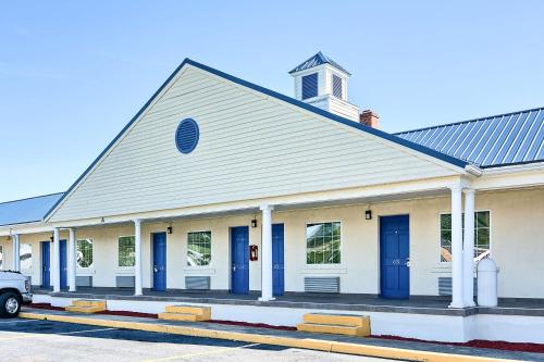 a church with blue doors on a street at Motel 6-Harrisonburg, VA - South in Harrisonburg