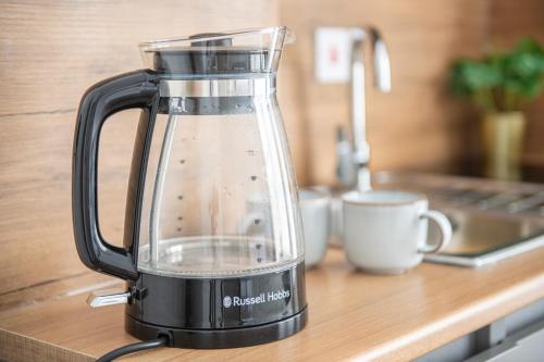 a blender sitting on a counter next to a cup at Nottingham Forest The City Ground Studio Apartments in Nottingham