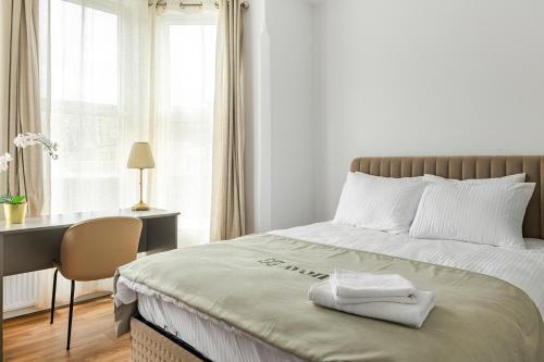 a bedroom with a bed with a desk and a window at Nottingham Forest The City Ground Studio Apartments in Nottingham
