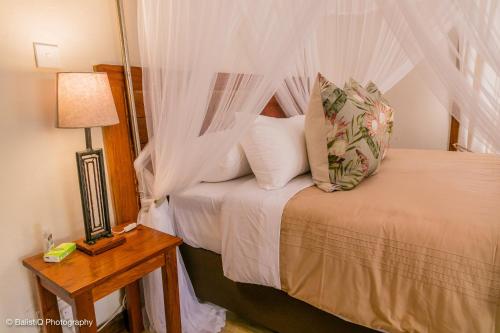 een slaapkamer met een bed met een witte klamboe bij The Sissing Santuary 