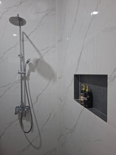 a shower in a bathroom with a glass wall at Juma cottages in Tuk Tuk