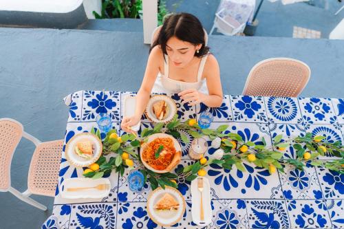 a young girl sitting at a table with a plate of food at Bintana Sa Paraiso in Mambajao
