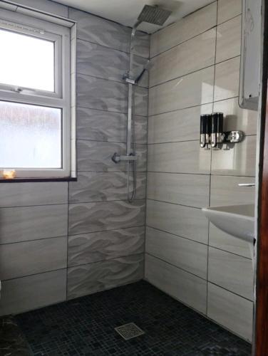 a bathroom with a shower and a sink at CityStay London in London