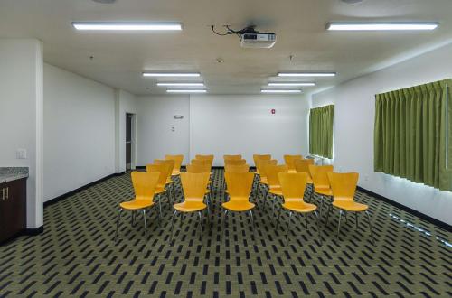 a conference room with yellow chairs in an office at Motel 6-South Bend, IN - Mishawaka in South Bend