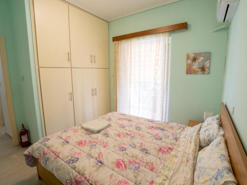 a bedroom with a bed with a laptop on it at DaMa Blue in Saronida