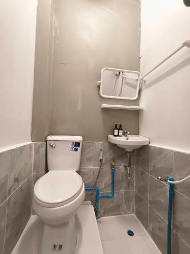 a bathroom with a toilet and a sink at SridaHouse#Near Central Festival Hatyai in Hat Yai