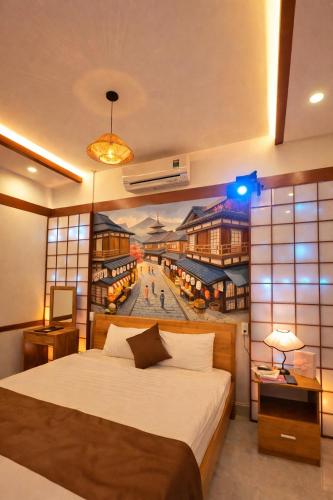 a bedroom with a large bed with a painting on the wall at Dopamine Hotel in Vung Tau