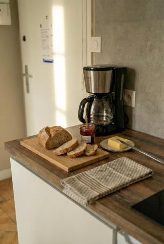 Een snijplank met brood erop, bovenop een aanrecht. bij Bois Émeraude in Aix-les-Bains