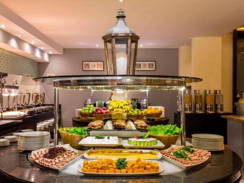 a buffet with many different types of food on display at Novotel Deira Creekside Dubai in Dubai