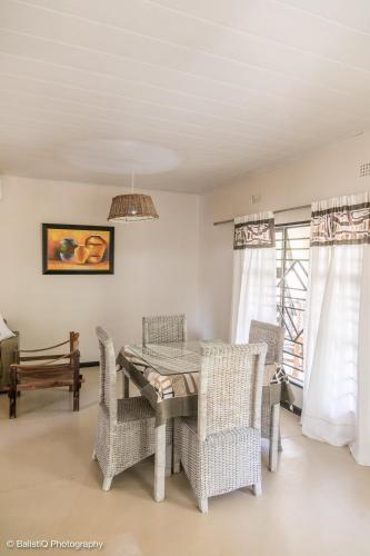 een eetkamer met een tafel en stoelen bij The Sissing Santuary 