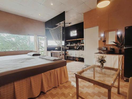 a room with a large bed and a table in it at Samstay Đà Lạt in Ấp Ða Lợi