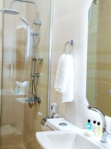 a bathroom with a sink and a shower with a mirror at I cloud Petra hostel in Wadi Musa