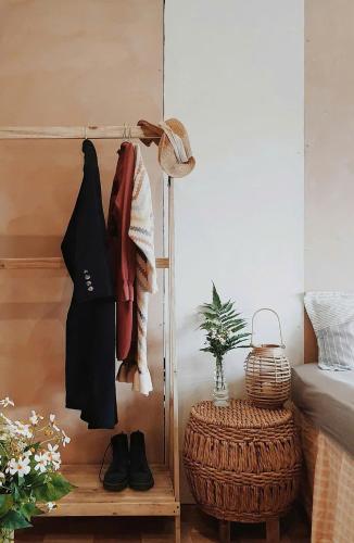 a room with a bed and a shelf with clothes at Samstay Đà Lạt in Ấp Ða Lợi