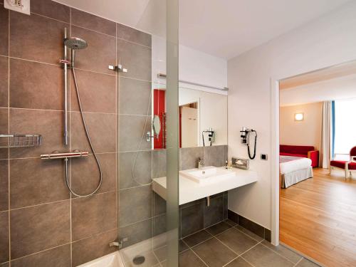a bathroom with a shower and a sink at Hôtel Mercure Vittel in Vittel