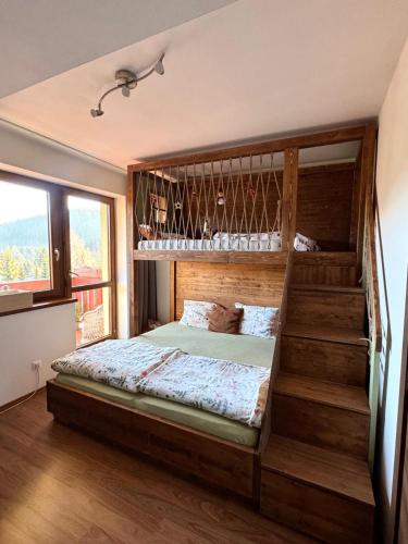 a bedroom with a bunk bed and a staircase at Apartman Kamzik Teo in Donovaly