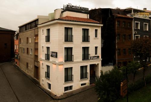 a white building with a sign on top of it at Pastel İstanbul in Istanbul